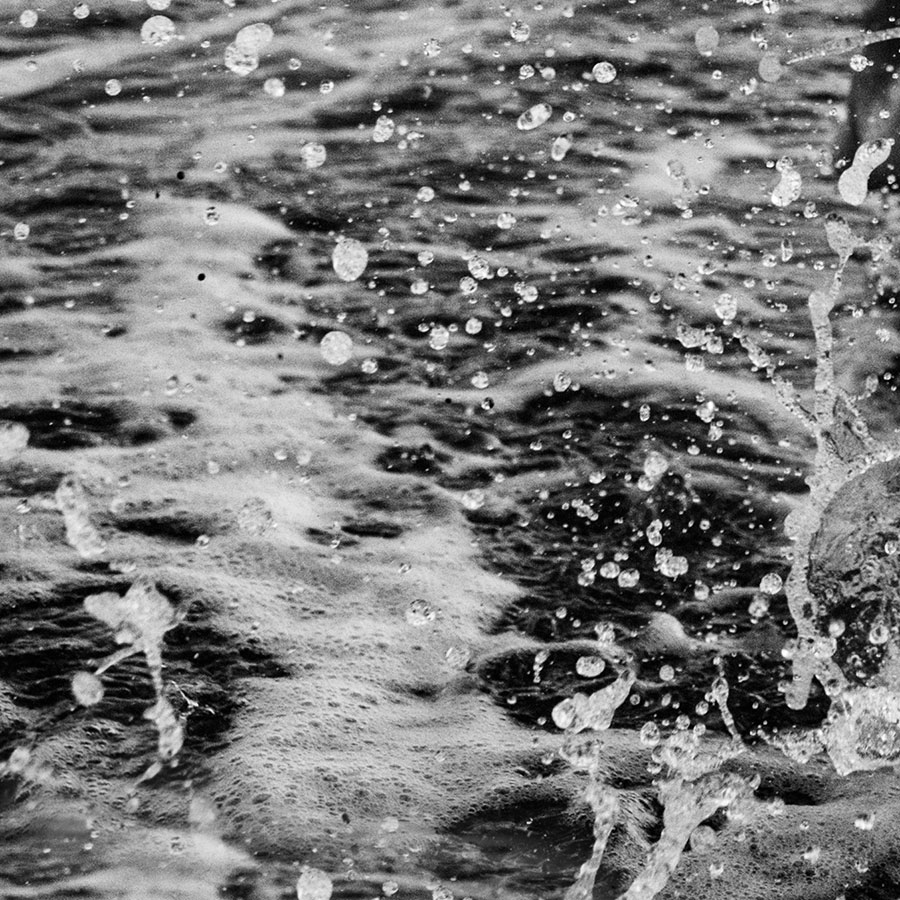 black and white image of beach water